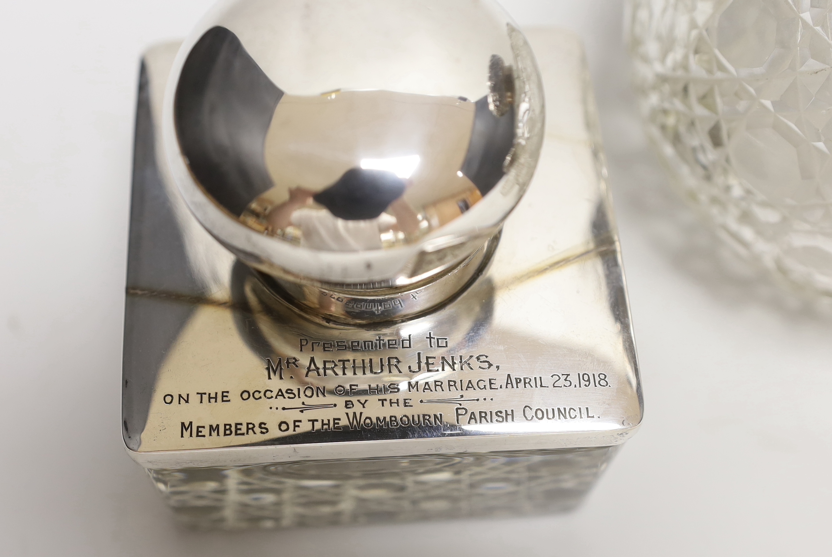 A George V silver mounted glass inkwell and three silver mounted cut glass scent bottles, largest 16cm (a.f.).